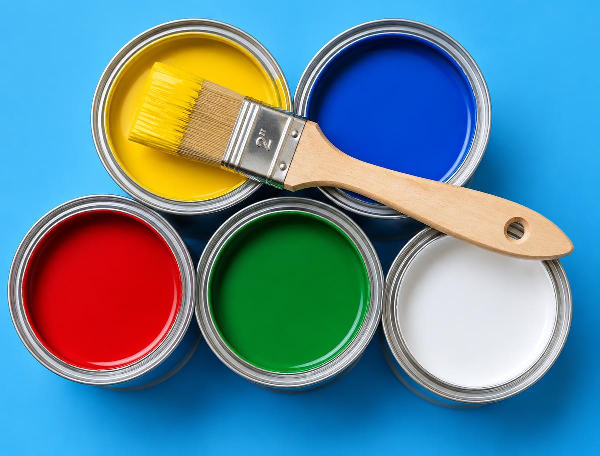 Open paint cans with a brush